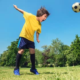 A young boy heads a ball during practice, the SFA have taken steps to restrict the amount of heading allowed by young players. Picture: Getty.