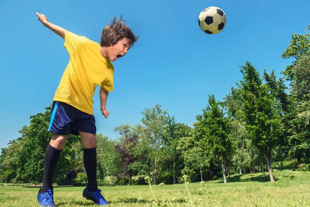 A young boy heads a ball during practice, the SFA have taken steps to restrict the amount of heading allowed by young players. Picture: Getty.