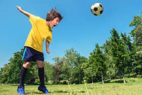 A young boy heads a ball during practice, the SFA have taken steps to restrict the amount of heading allowed by young players. Picture: Getty.