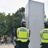 Police guard the boxed statue of Churchill in Parliament Square, London. Picture: Dominic Lipinski/PA