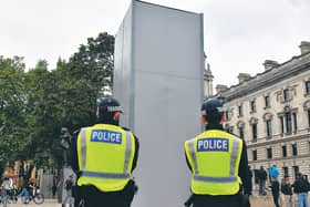 Police guard the boxed statue of Churchill in Parliament Square, London. Picture: Dominic Lipinski/PA