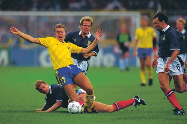 Tomas Brolin of Sweden is brought down by Scotland's Gordon Durie, with Murdo MacLeod and Maurice Malpas close by. Picture: Simon Bruty/Allsport