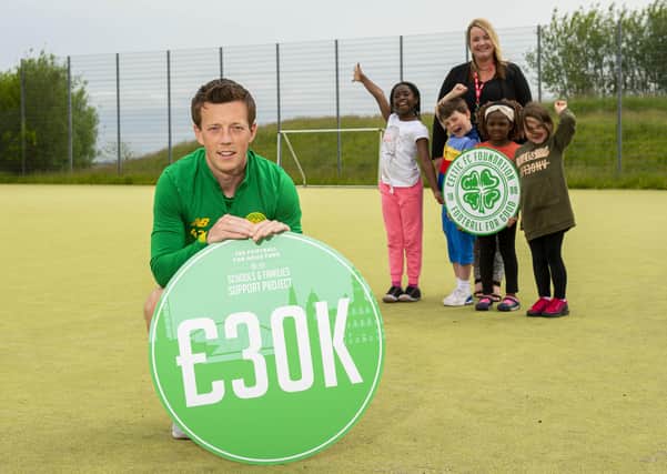 Callum McGregor with St Teresa’s Primary School head teacher Lesley Fee and children from local schools as Celtic make a £30,000 donation to 12 local schools and nurseries as part of their Football For Good Fund. Picture: SNS
