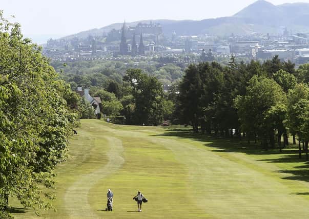 A couple of golfers respecting the lockdown two-ball limit and the two-metre social distancing rule as they play at Murrayfield GC. Picture: Lisa Ferguson