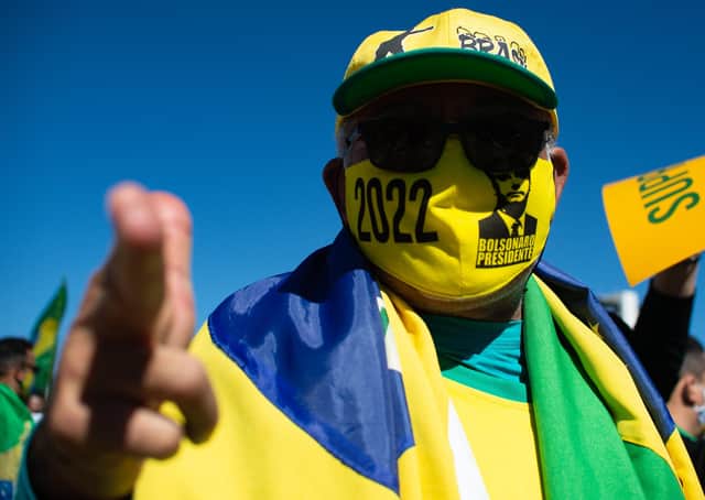 A supporter of Jair Bolsonaro wears a mask just like the controversial Brazilian President now does, after a judge ordered him to (Picture: Andressa Anholete/Getty Images)