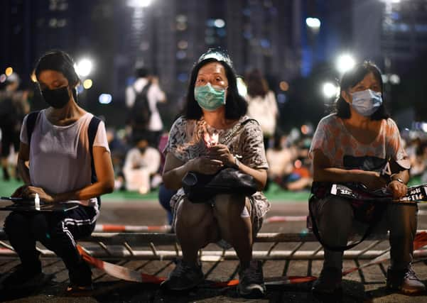 Activists hold a candlelit remembrance in Victoria Park in Hong Kong for the victims of the 1989 Tiananmen Square crackdown (Picture: Anthony Wallace/AFP via Getty Images)