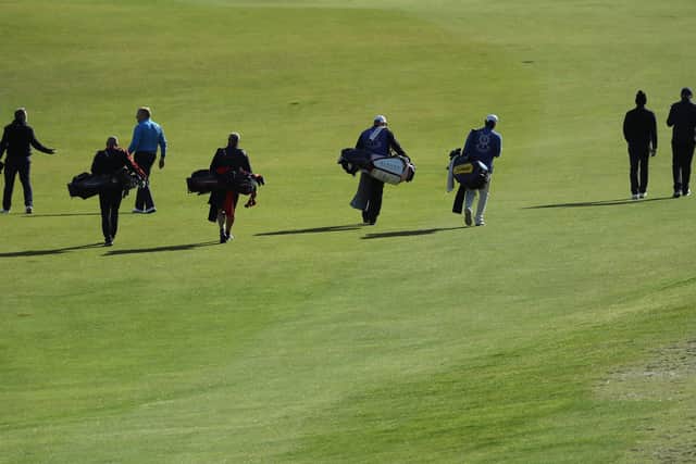 Golfers and caddies walk the course at Kingsbarns. Picture: Warren Little/Getty Images)