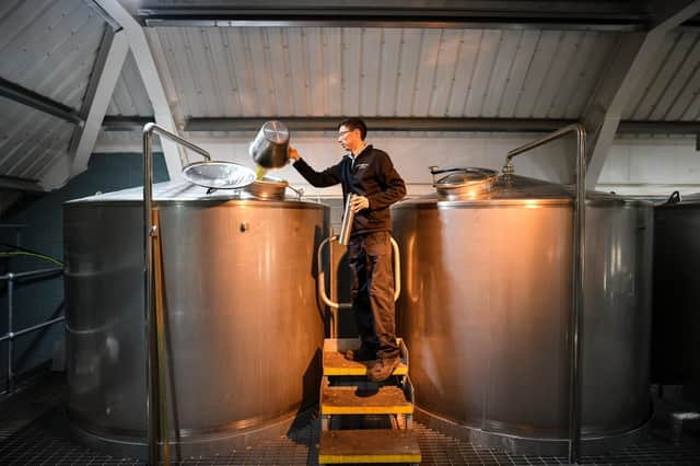 Kingsbarns distillery manager Peter Holroyd takes a dip and gravity test from the washback in St Andrews, Scotland. Picture: Jeff J Mitchell/Getty Images