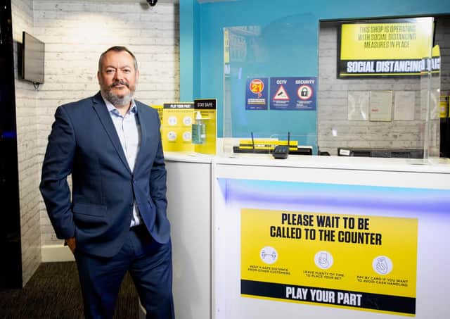 Michael Dugher in a Coral betting shop in London. Bookmakers in Scotland have taken similar social distancing steps, but are subject to tighter restrictions on their operations
