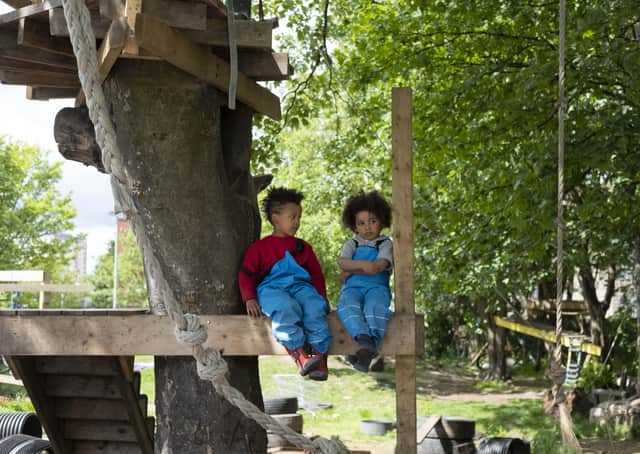 Children resting in a treehouse at the Baltic Street Adventure Playground