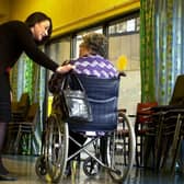 A staff member speaks to a care home resident