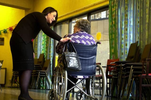 A staff member speaks to a care home resident