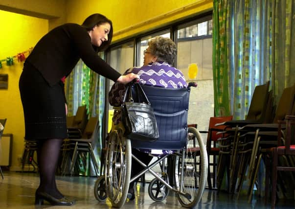 A staff member speaks to a care home resident