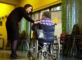 A staff member speaks to a care home resident