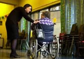 A staff member speaks to a care home resident