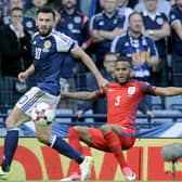 Robert Snodgrass, left, in action for Scotland against England in 2017 has hinted that he would welcome a return to international football. Picture: Michael Gillen.