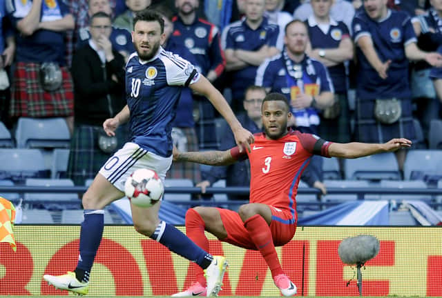 Robert Snodgrass, left, in action for Scotland against England in 2017 has hinted that he would welcome a return to international football. Picture: Michael Gillen.