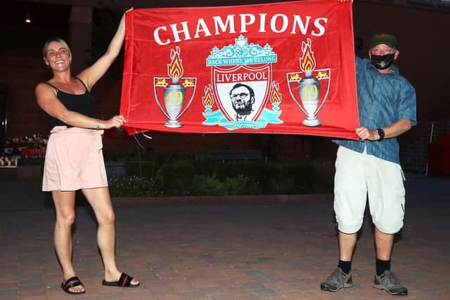 Fans fly the flag at Anfield after Liverpool's title was confirmed by Chelsea's win over Man City. Picture: Martin Ricketts/PA Wire