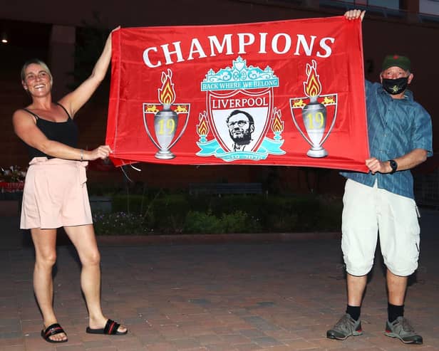 Fans fly the flag at Anfield after Liverpool's title was confirmed by Chelsea's win over Man City. Picture: Martin Ricketts/PA Wire