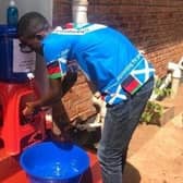 Malawi Scotland Partnership staff in Lilongwe installing Covid-19 handwashing stations