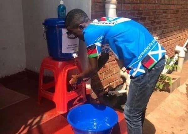 Malawi Scotland Partnership staff in Lilongwe installing Covid-19 handwashing stations