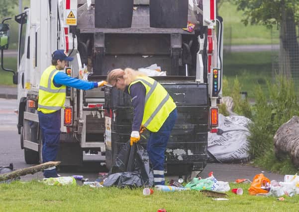 Edinburgh City Council employees clear up a large amount of waste left discarded in the Meadows last month