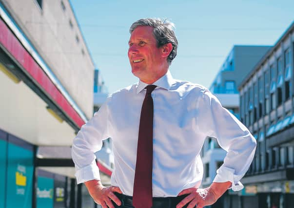 Sir Keir Starmer walks through a pedestrianised area as he makes a visit to small businesses in Stevenage