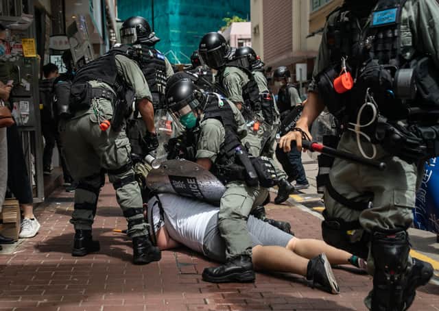 A man is detained by riot police during a protest against draconian new laws in Hong Kong (Picture: Anthony Kwan/Getty Images)