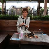 First Minister Nicola Sturgeon sits by a fire pit table during a visit to Cold Town House in Edinburgh's Grassmarket. Picture: Andrew Milligan - Pool/Getty Images