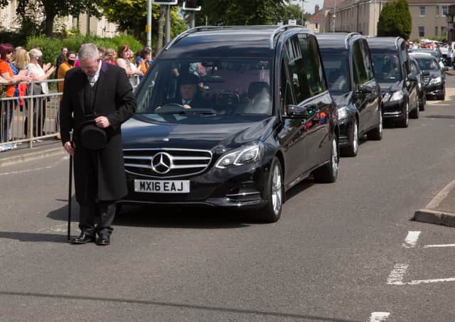 Friends and local residents line the streets to pay their respects at the funeral procession of Fiona Gibson, 12, Alexander James Gibson, eight, and five-year-old Philip Gibson, the three children who died in a house fire in Paisley, Renfrewshire. Picture: Robert Perry/PA Wire