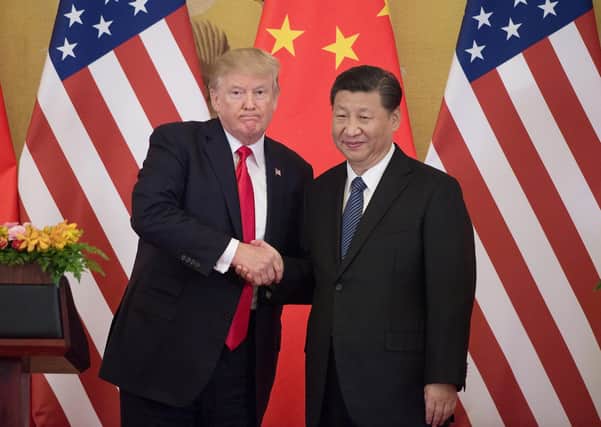 US President Donald Trump shakes hands with China's President Xi Jinping during a press conference at the Great Hall of the People in Beijing in 2017 (Picture: Nicolas Asfouri/AFP/Getty Images)