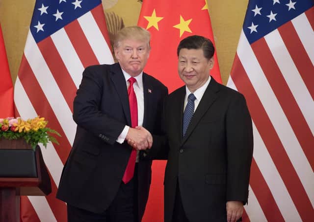 US President Donald Trump shakes hands with China's President Xi Jinping during a press conference in Beijing (Picture: Nicolas Asfour/AFP/Getty Images)