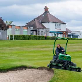 A groundsman at Carrick Knowe gets the course ready for reopening. Picture: SNS.
