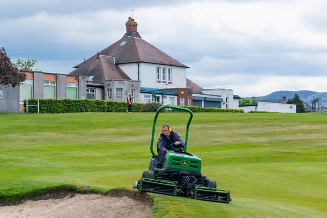 A groundsman at Carrick Knowe gets the course ready for reopening. Picture: SNS.