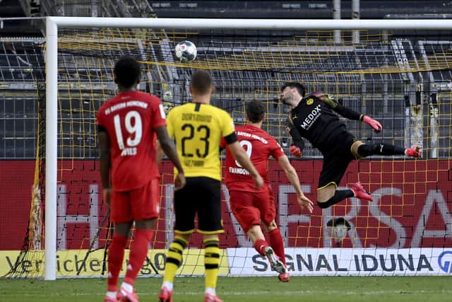 Dortmund goalkeeper Roman Burki fails to save a chip by Munich's Joshua Kimmich. Picture: Federico Gambarini/AP