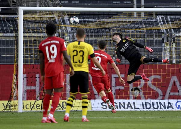 Dortmund goalkeeper Roman Burki fails to save a chip by Munich's Joshua Kimmich. Picture: Federico Gambarini/AP