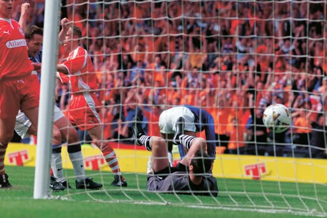 Aberdeen's stand-in goalkeeper Robbie Winters is left helpless as Giovanni Van Bronkhorst runs off to celebrate his goal.