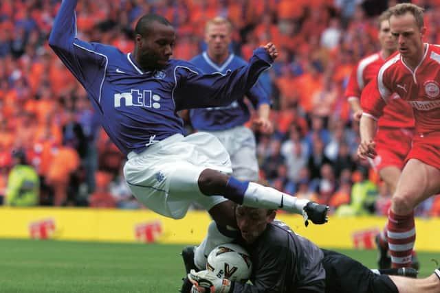 Agony for Aberdeen keeper Jim Leighton as Rangers' Rod Wallace collides with him in the 2000 Scottish Cup final.