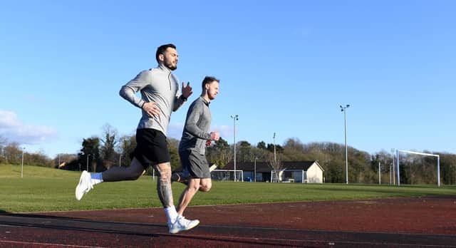 Motherwell striker Tony Watt and goalkeeper Trevor Carson pictured training at Dalziel Park in March after Scottish football was suspended due to the cornonavirus pandemic. Picture: Craig Williamson/SNS Group