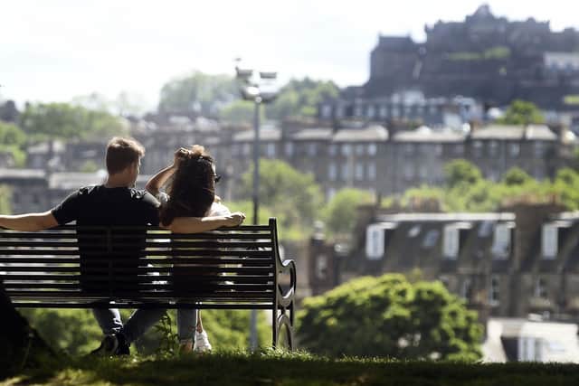 A couple enjoy the warm weather at Inverleith Park. Picture: Lisa Ferguson