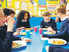 Pupils eating school meals and talking