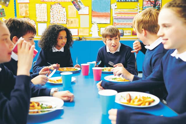 Pupils eating school meals and talking