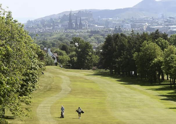 Golfers walk down a fairway at Murrayfield Golf Club in Edinburgh as the sport resumed in Scotland. Picture: Lisa Ferguson