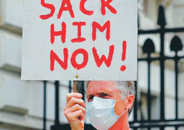 A protester holds a placard demanding the sacking of the Prime Minister's aide. Picture: Tolga Akmen/Getty