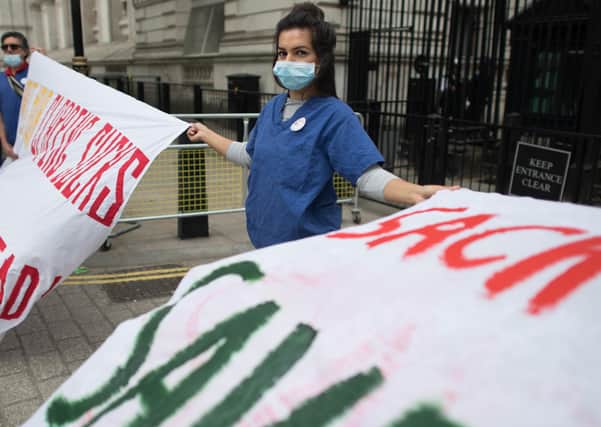 Nurse Ameera Sheikh protests at Downing Street over pay, better protection against Covid and and information about BAME NHS staff deaths (Picture: Stefan Rousseau/PA Wire)