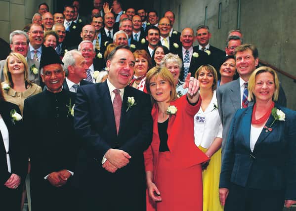Alex Salmond then SNP leader and his deputy Nicola Sturgeon stands with SNP's 47 newly elected MSP's after taking their oath in a swearing in ceremony at the Scottish Parliament May 9, 2007. Picture: Getty