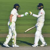 Jos Buttler, left, and Chris Woakes fist bump during England's remarkable comeback. Picture: Dan Mullan/AP