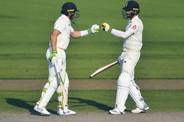 Jos Buttler, left, and Chris Woakes fist bump during England's remarkable comeback. Picture: Dan Mullan/AP