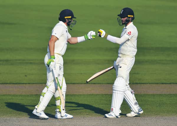 Jos Buttler, left, and Chris Woakes fist bump during England's remarkable comeback. Picture: Dan Mullan/AP