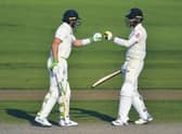 Jos Buttler, left, and Chris Woakes fist bump during England's remarkable comeback. Picture: Dan Mullan/AP